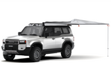 White SUV with an extended Alu-Cab 270 Shadow Awning. Camp4x4. camp 4x4, overlanding, camping.