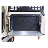 Alu-Cab Rear Door Drop Down Table mounted to a vehicle on a white background