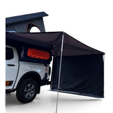 Off-road camping vehicle fitted with a hard shell rooftop tent and an Alu-Cab 270 awning, with the universal side panel in place