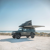 Camp4x4 Suzuki Jimny with a rooftop tent and 2m 270 Shadow awning on a beach