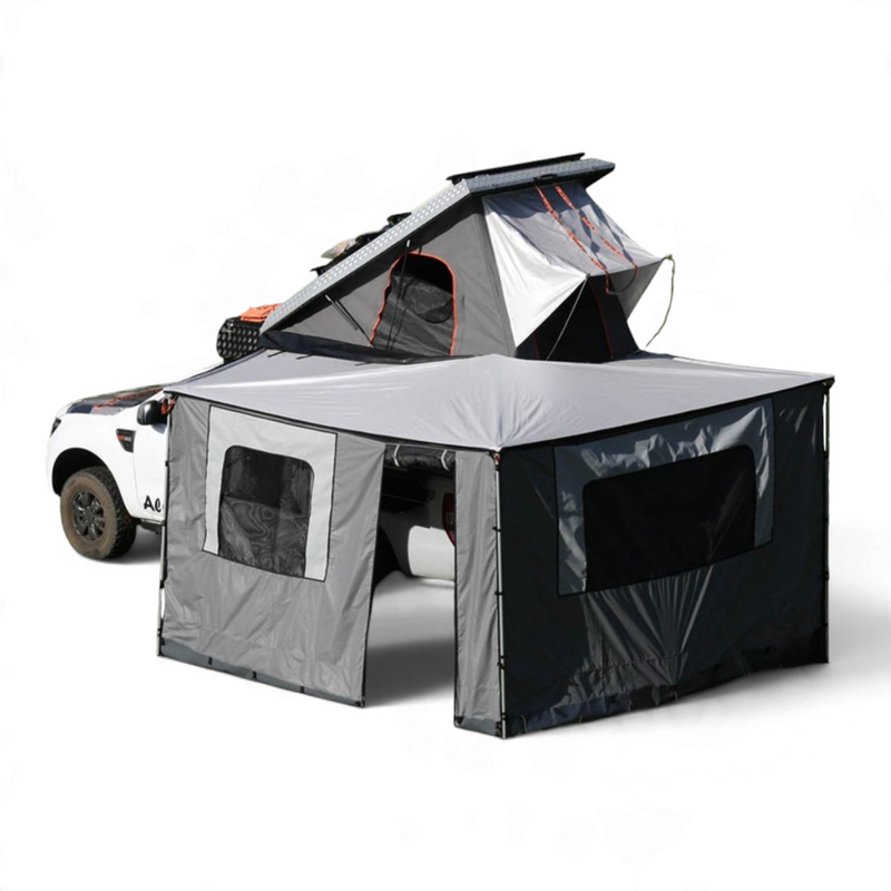 Alu-Cab 270 awning, with the Awning Side Wall Kit and a hard shell rooftop tent, fitted to a camping vehicle