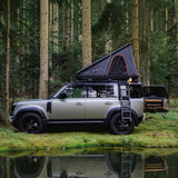 A Camp4x4 rental vehicle, fitted with the Alu-Cab LT-50 Lightweight rooftop tent, in a forrest setting