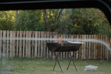 Braai grid on top of a fire drum in an outdoor setting.