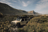 Jimny in a scenic mountainous area with 'CAMP4x4' branding