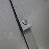 A close up view of the MEERKAT Canvas Folding Mattress showing the rip-stop canvase quality and a clipped strap