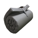 A close up view of the MEERKAT Canvas Roll-Up Mattress, showing the product rolled up, displayed on a white background