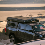 Black double cab Toyota Hilux fitted with the Alu-Cab Contour Canopy and the Gen3.R Rooftop Tent and 270 Shadow awning. Camp4x4 camp 4x4, overlanding, camping. Single Cab. Extra Cab