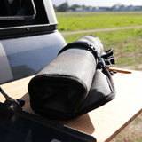 Alu-Cab Cutlery Roll Deluxe on a truck bed with mountains in the background