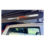 Alu-Cab MODCAP Family Tent Table Slide Fitted to an off-road vehicle on a white background