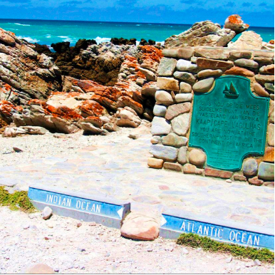 Beach scene with rocks, ocean, and 'Due South' branding.
