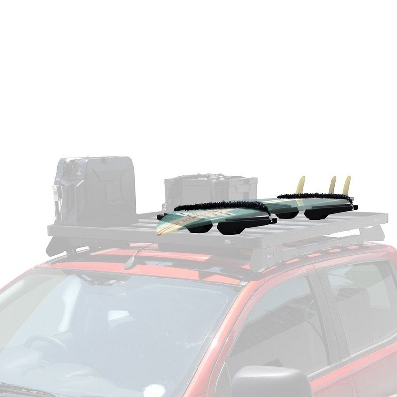 Two surfboards with black fins attached to a Front Runner Pro Surfboard, Windsurf & Paddle Board Carrier on a roof rack mounted on a red vehicle, shown against a plain white background.