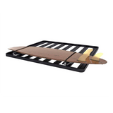 A Front Runner Pro Surfboard, Windsurf & Paddle Board Carrier designed to carry a surfboard on a roof rack, shown empty against a solid white background.