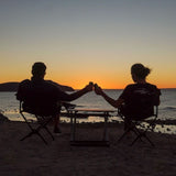 two people sitting in Front Runner Expander Camping Chairs enjoying a sunset 