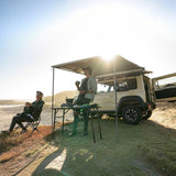 two people around a Camp4x4 vehicle with camp gear and Folding Front Runner Expander Camping Chairs 