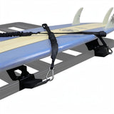 A blue and cream surfboard on a Front Runner Vertical Surfboard Carrier, mounted to a roof rack, photographed against a white background.