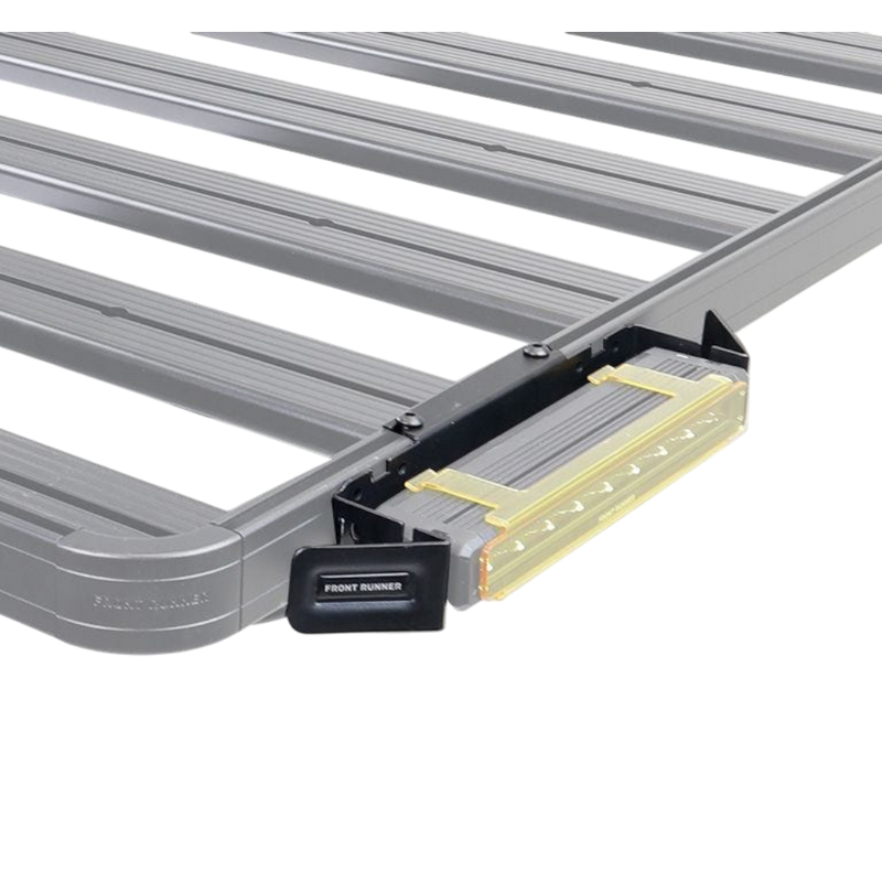A close-up of a gray metal roof rack crossbar system with a Front Runner Series 10" LED Light Bar VX250-FL Mounting Bracket, shown on a white background.