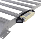 A close-up of a silver metal roof rack with a black Front Runner Series 10" LED Light Bar VX250-FL Mounting Bracket, isolated on a white background.