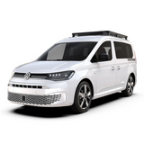 A white Volkswagen Caddy van with a Front Runner Series Volkswagen Caddy (2022-Current) Slimline II Roof Rack Kit, shown from a three-quarter front angle on a clean white background.