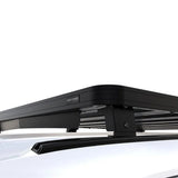 Black Front Runner Series Volkswagen Caddy (2022-Current) Slimline II Roof Rack Kit mounted on a white vehicle, shown from a high-angle close-up view with the brand name 'Front Runner' visible on the side.