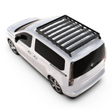 A Front Runner Series Volkswagen Caddy / Ford Transit/Tourneo Connect SWB (2020-Current) Slimline II Roof Rack Kit mounted on the roof of a white minivan, shown from a high-angle studio perspective on a white background.