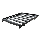 A black Front Runner Toyota Corolla Cross (2020-Current) Slimline II Roof Rack Kit with a slatted top and mounting feet, shown at an angle on a plain white background.