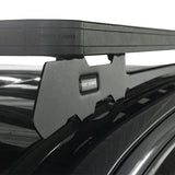 Close-up of a blackFront Runner Series Isuzu D-MAX RG/3rd Gen (2020-Current) Slimline II Roof Rack Kit mounted to a vehicle roof with a matching black mounting bracket. The words 'FRONT RUNNER' are visible on both the crossbar and the bracket.