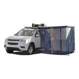A white SUV with a dark blue Front Runner Series Easy-Out Awning Mosquito Net for a 2M or 2.5M awning, attached to the side, shown on a plain white background.