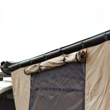 Close-up of a beige and dark gray Front Runner Series Easy-Out Awning Room for a 2m or 2.5m Awning, attached to a black roof rack over a vehicle, with the fabric rolled at the top right.