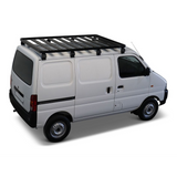 A white cargo van with a Front Runner Suzuki Eeco (2023-Current) Slimline II Roof Rack Kit, shown from a three-quarter rear angle on a clean white background.

 