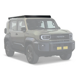 A green Toyota SUV with a black Front Runner Toyota Land Cruiser FJ (2026-Current) Slimsport Roof Rack Kit, shown from a three-quarter front angle on a light gray background.