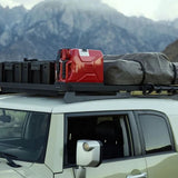 Toyota SUV with Front Runner Toyota FJ Cruiser Slimline II Roof Rack Kit in the outdoors with mountains