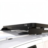 A Front Runner Ford Transit Custom LWB (2023-Current) Slimline II Roof Rack Kit shown installed on the roof of a white vehicle against a white studio background.