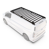 A Front Runner Ford Transit Custom LWB (2023-Current) Slimsport Rack Kit / Lightbar Readymounted on the roof of a white van, shown from a high-angle perspective against a plain white background.