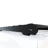 A Front Runner Ford Transit Custom LWB (2023-Current) Slimsport Rack Kit / Lightbar Ready mounted onto the white roof of a vehicle, shown against a clean white background. The brand label 'FRONT RUNNER' is visible on the mounting bracket.
