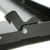Close-up of a black Front Runner Fridge Slide with a textured steel locking mechanism  and a silver hex bolt, shown against a white background.