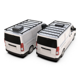Two white vans shown from the rear three-quarter angle on a clean white background, each fitted with a Front Runner Toyota HiAce LWB (2019-Current) Slimpro Roof Rack Kit mounted on top.