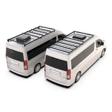 Two white vans shown from elevated rear-three-quarter angles on a clean white background, each fitted with a black Front Runner Series Toyota HiAce SLWB High Roof (2019-Current) Slimpro Roof Rack Kit.