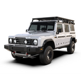 A white off-road SUV with a black Front Runner Ineos Grenadier (2022-Current) Slimline II Roof Rack Kit and black front bumper, photographed on a clean white studio background.