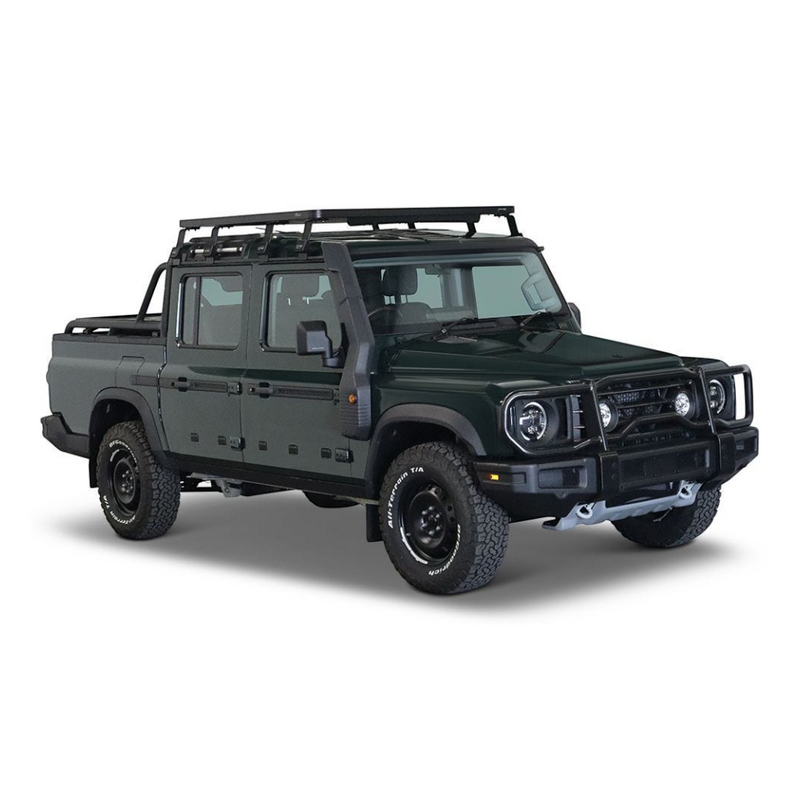 A dark green off-road pickup truck with aFront Runner Ineos Grenadier Quartermaster Slimline II Roof Rack Kit, front bumper guard, and off-road tires, shown from a three-quarter angle on a white background.