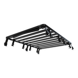 A black Front Runner Ineos Grenadier (2022-Current) Slimline II 3/4 Roof Rack Kit mounted cargo bed rack with a slatted design, shown from an elevated perspective against a plain white background.