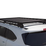 A black Front Runner Series Isuzu MU-X (2021-Current) Slimline II Roof Rack Kit mounted on the roof of a white SUV, shown against a plain white background.