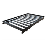 A black Front Runner Toyota Land Cruiser 300 Slimline II Roof Rack Kit with a slatted top, shown at an angle on a plain white background.