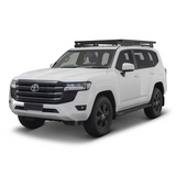 A white Toyota SUV with a Front Runner Toyota Land Cruiser 300 Slimline II Roof Rack Kit, shown from a three-quarter front angle on a clean white background.