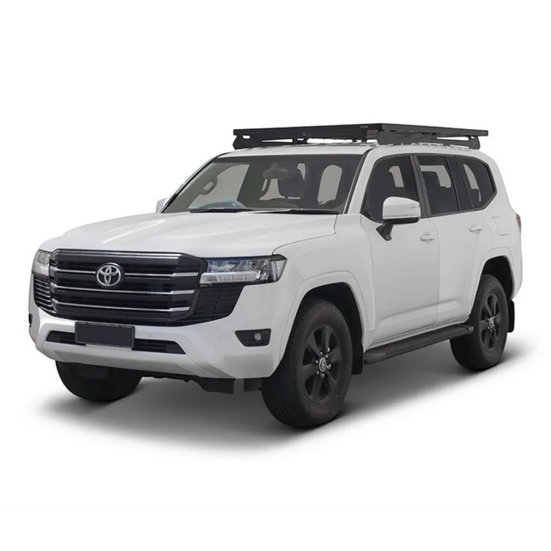 A white Toyota SUV with a Front Runner Toyota Land Cruiser 300 Slimline II Roof Rack Kit, shown from a three-quarter front angle on a clean white background.