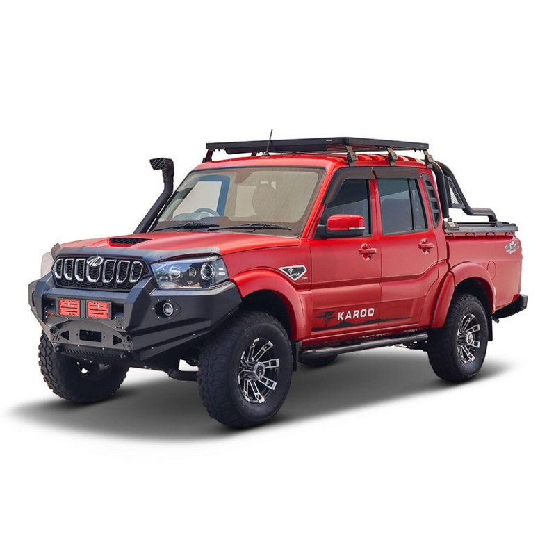 A red pickup truck with a black front bumper, black Front Runner Mahindra Pik-Up Double Cab (2006-Current) Slimline II Roof Rack Kit, and black side steps, shown from a three-quarter angle on a white background.