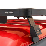 Black Front Runner Mahindra Pik-Up Double Cab (2006-Current) Slimline II Roof Rack Kit branded FRONT RUNNER, shown mounted on a glossy red vehicle roof against a white studio background.