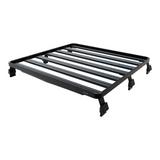 A black Front Runner Mahindra Pik-Up Double Cab (2006-Current) Slimline II Roof Rack Kit with a slatted top and mounting feet, shown at an angle on a plain white background.