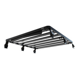 A black Front Runner Mahindra Pik-Up Double Cab (2006-Current) Slimline II Roof Rack Kit with multiple parallel horizontal bars and mounting brackets, shown at an angle against a plain white background.