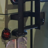 Close-up of a Front Runner Land Rover Defender 90/110 (1983-2016) Ladder on an olive green vehicle or panel, with a red taillight visible on the left.