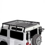 White Land Rover vehicle with a Front Runner Land Rover Defender 90 (1983-2016) Slimline II Roof Rack Kit on a white background